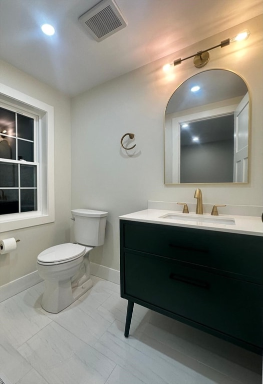 bathroom featuring vanity and toilet