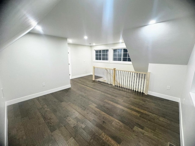 bonus room featuring lofted ceiling and dark wood-type flooring