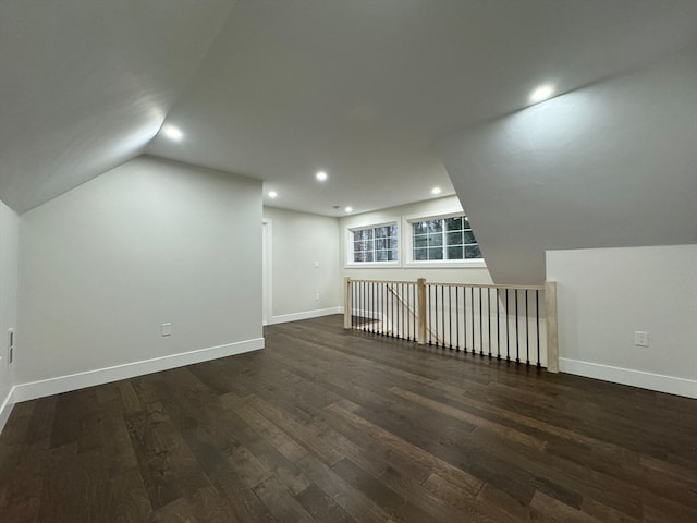 additional living space with dark hardwood / wood-style floors and lofted ceiling