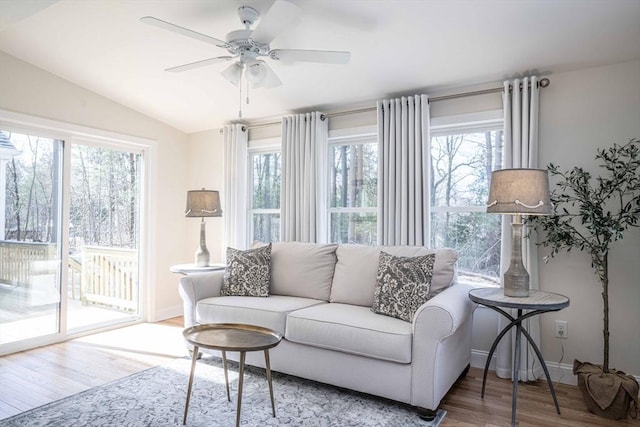 sunroom / solarium featuring lofted ceiling, ceiling fan, and a wealth of natural light