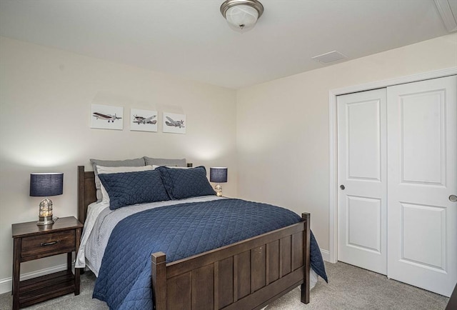 bedroom with light colored carpet and a closet