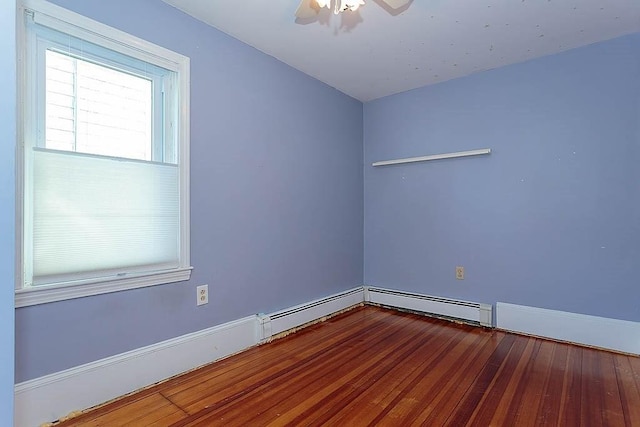 unfurnished room with ceiling fan, a baseboard radiator, baseboards, and wood finished floors