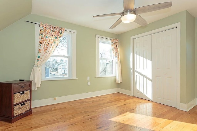 bedroom featuring a closet, baseboards, and light wood finished floors