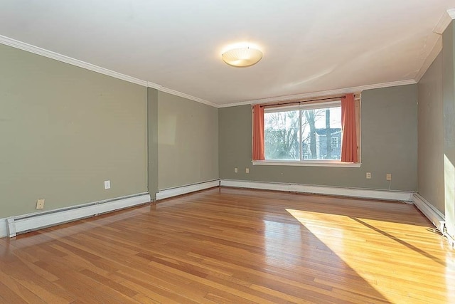 spare room featuring baseboard heating, light wood-style flooring, baseboards, and ornamental molding