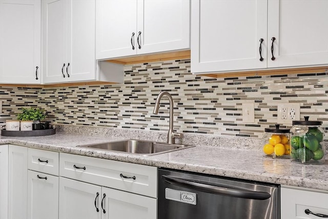 263 Meeting House Path Unit 263, Ashland, MA 01721 - kitchen with stainless steel dishwasher, a sink, white cabinetry, decorative backsplash, and light stone counters
