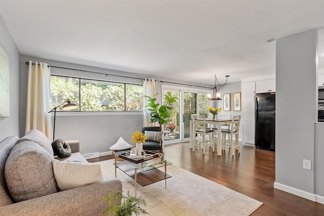 263 Meeting House Path Unit 263, Ashland, MA 01721 - living room with a chandelier, baseboards, and dark wood-style floors