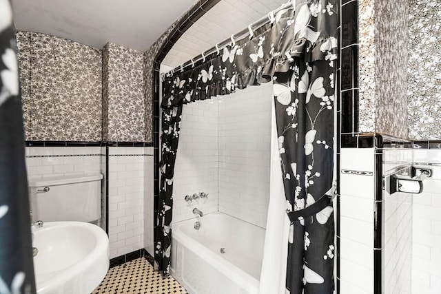 bathroom with tile patterned floors, tile walls, and shower / bath combination with curtain