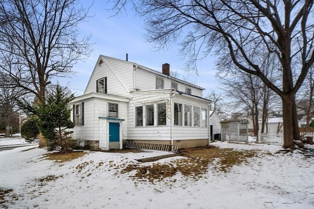 view of snow covered back of property