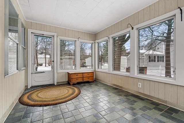 unfurnished sunroom featuring plenty of natural light