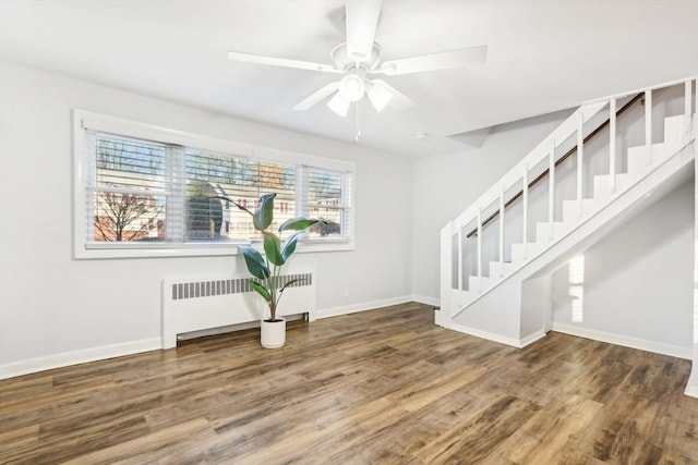 entrance foyer featuring radiator, ceiling fan, and dark wood-type flooring