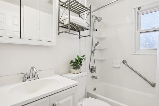 full bathroom featuring vanity, toilet, and tiled shower / bath combo