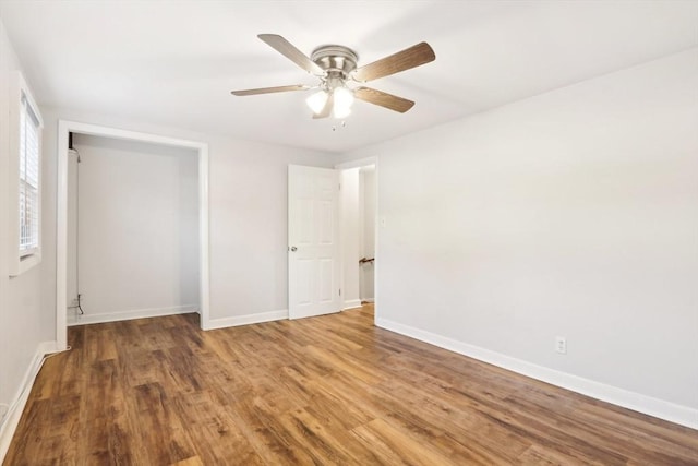 unfurnished bedroom with a closet, hardwood / wood-style flooring, and ceiling fan