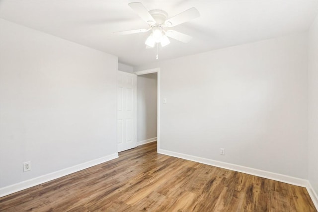 unfurnished room with hardwood / wood-style floors and ceiling fan