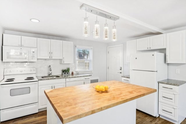 kitchen with white cabinetry, sink, dark wood-type flooring, white appliances, and a kitchen island