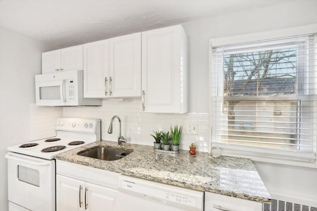 kitchen featuring white cabinets, decorative backsplash, white appliances, and sink