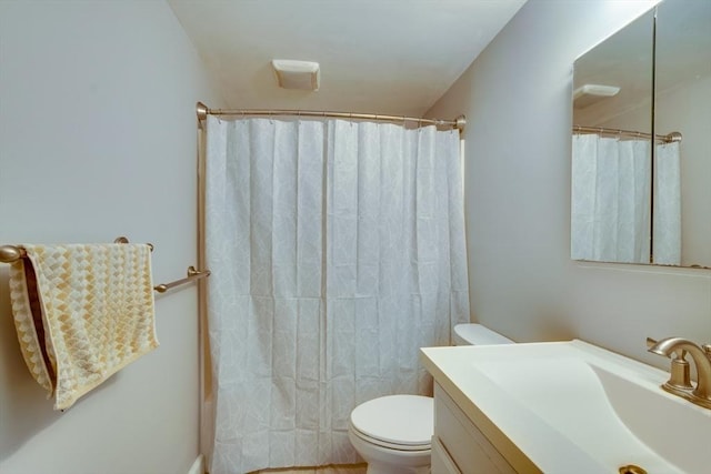 bathroom featuring vanity, curtained shower, and toilet