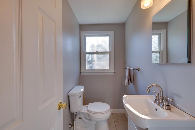 bathroom featuring tile patterned flooring, sink, a wealth of natural light, and toilet