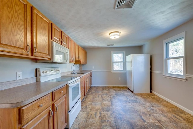 kitchen featuring sink and white appliances