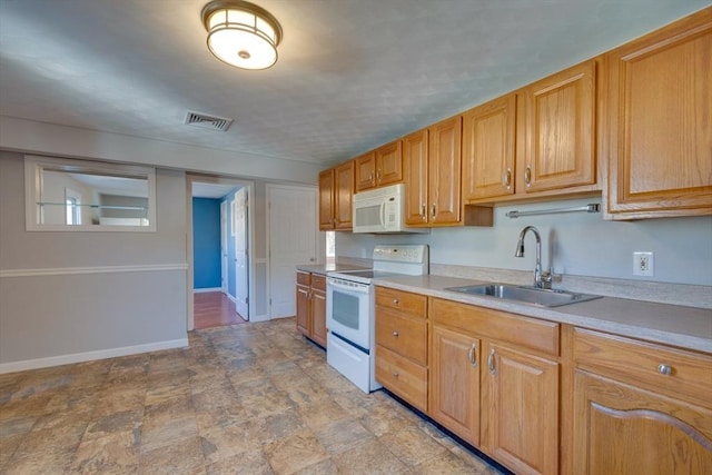 kitchen featuring sink and white appliances