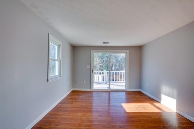 unfurnished room with wood-type flooring