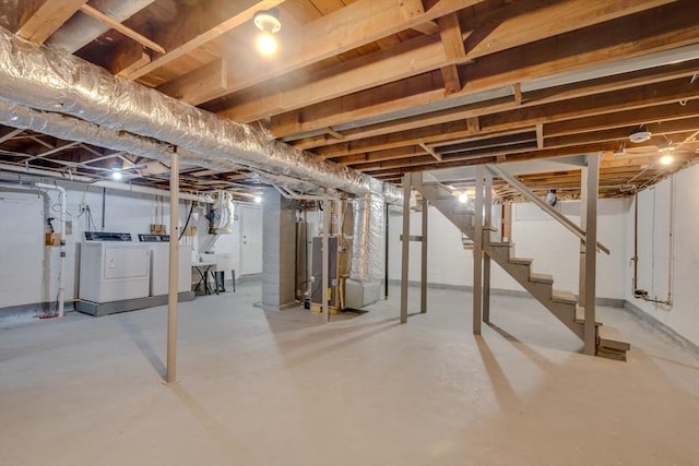 basement featuring separate washer and dryer and heating unit