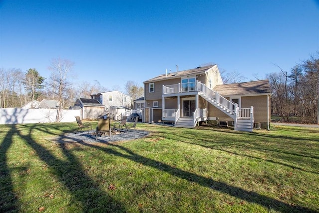 rear view of house with a deck and a lawn