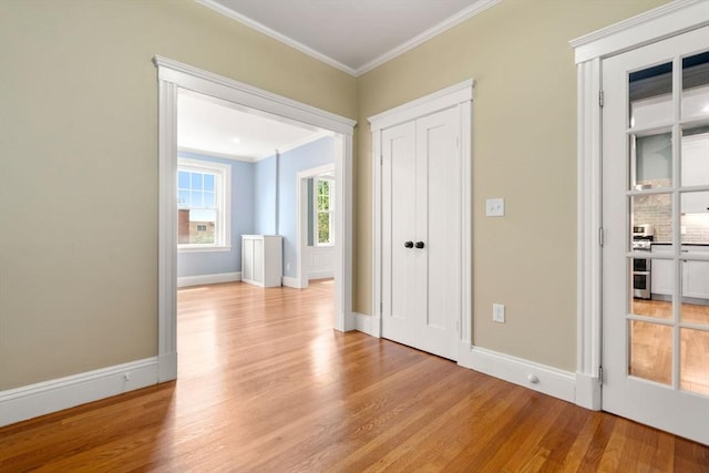 132 Sewall St Unit C, Brookline, MA 02446 - unfurnished bedroom featuring ornamental molding, light wood-style floors, baseboards, and a closet