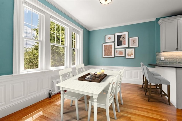 132 Sewall St Unit C, Brookline, MA 02446 - dining space featuring ornamental molding, light wood-type flooring, and a wainscoted wall