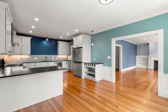 132 Sewall St Unit C, Brookline, MA 02446 - kitchen with appliances with stainless steel finishes, dark countertops, a sink, ornamental molding, and tasteful backsplash