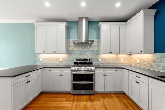 132 Sewall St Unit C, Brookline, MA 02446 - kitchen with double oven range, island range hood, a peninsula, dark countertops, and recessed lighting