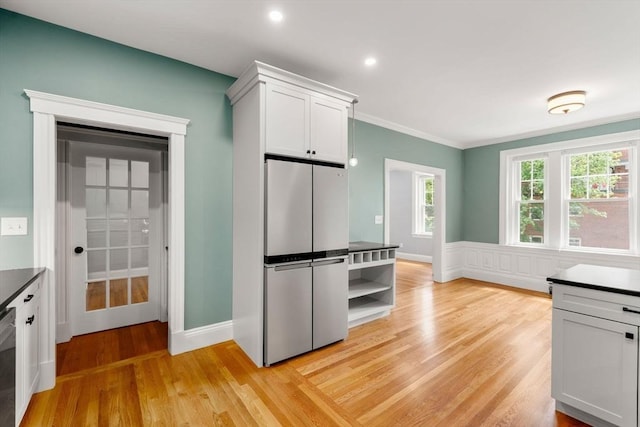 132 Sewall St Unit C, Brookline, MA 02446 - kitchen featuring stainless steel appliances, light wood-style flooring, crown molding, dark countertops, and white cabinetry