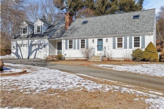 cape cod home featuring a garage