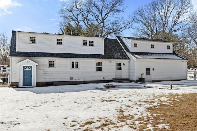 view of snow covered back of property