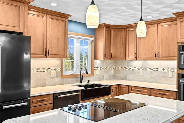 kitchen with hanging light fixtures, sink, black appliances, and decorative backsplash