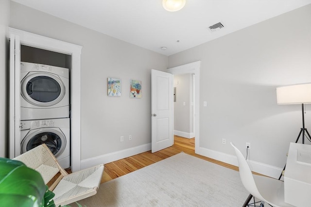 50 Alpine St Unit 2, Somerville, MA 02144 - laundry area featuring stacked washer / dryer, wood finished floors, and baseboards