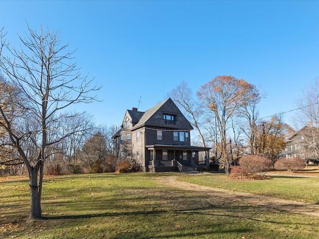 view of front facade with a front yard and a porch