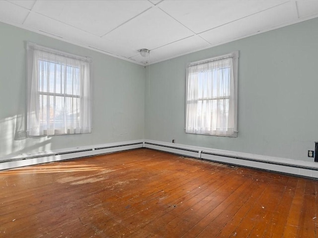 spare room featuring a paneled ceiling and wood-type flooring