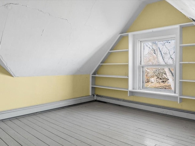 bonus room with lofted ceiling, baseboard heating, and light hardwood / wood-style flooring