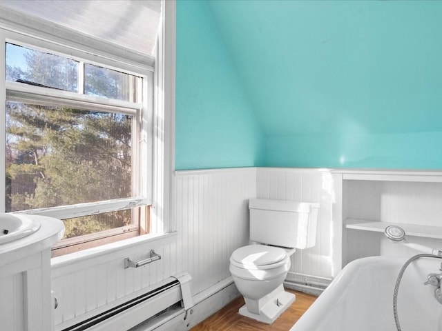 bathroom with baseboard heating, wood-type flooring, lofted ceiling, toilet, and a tub