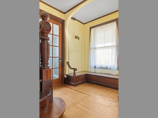 interior space featuring ornamental molding and light wood-type flooring