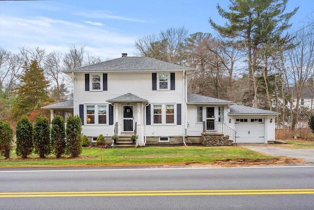 view of front of home featuring a front yard and a garage