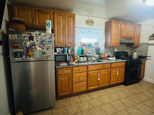 19 6th St, Chelsea, MA 02150 - kitchen with light tile patterned floors, tasteful backsplash, appliances with stainless steel finishes, and under cabinet range hood