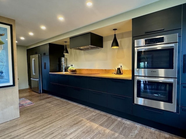 kitchen featuring wooden counters, stainless steel appliances, hanging light fixtures, and range hood