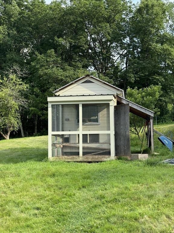 view of outdoor structure with a lawn