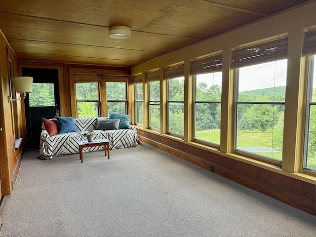 unfurnished sunroom with plenty of natural light and wooden ceiling