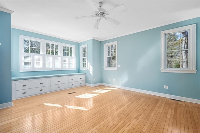 unfurnished bedroom with ornamental molding, light wood finished floors, and baseboards