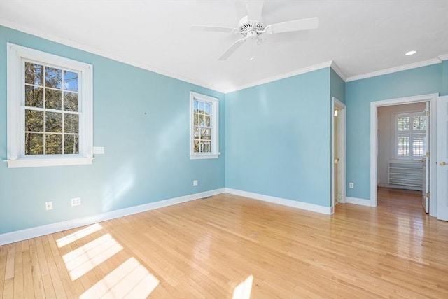 unfurnished room featuring ornamental molding, light wood-type flooring, ceiling fan, and baseboards