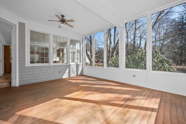 unfurnished sunroom with a ceiling fan