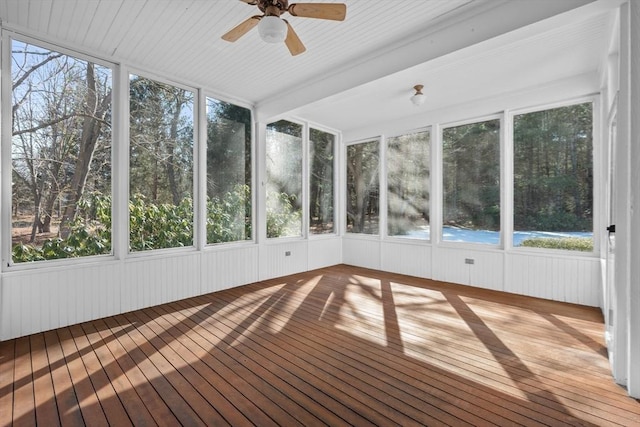 unfurnished sunroom featuring a ceiling fan