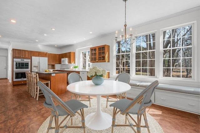 dining space featuring a chandelier, recessed lighting, and crown molding